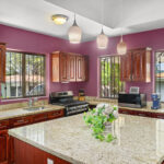 Kitchen with custom wood cabinetry and a granite island