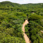 Aerial over the wooded hillside lots