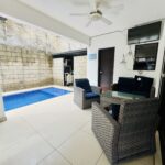 4-bedroom villa with pool in Colinas de Miramar — poolside lounge seating