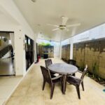 Covered terrace with dining table beside the pool