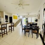 Open living and dining area with breakfast bar and ceiling fans