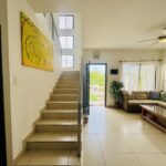 Stairway and living room opening to the terrace