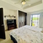 Bedroom with TV wall and balcony access