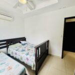 Bedroom with air conditioning and dark wood bed