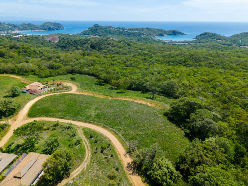 Panoramic ocean view lot near TreeCasa — aerial of the lot with San Juan del Sur Bay beyond