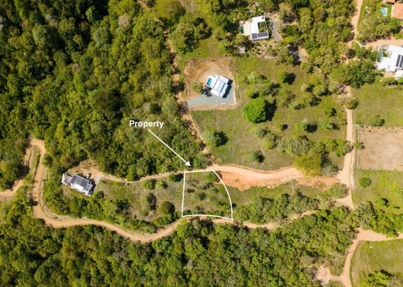 Top-down aerial with the lot boundary marked along the access road