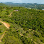 Hillside and access road leading to the lot