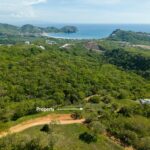Panoramic views near TreeCasa — lot marked on the hillside with the bay beyond