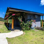 House on land in Big Sky Ranch — front facade with bougainvillea