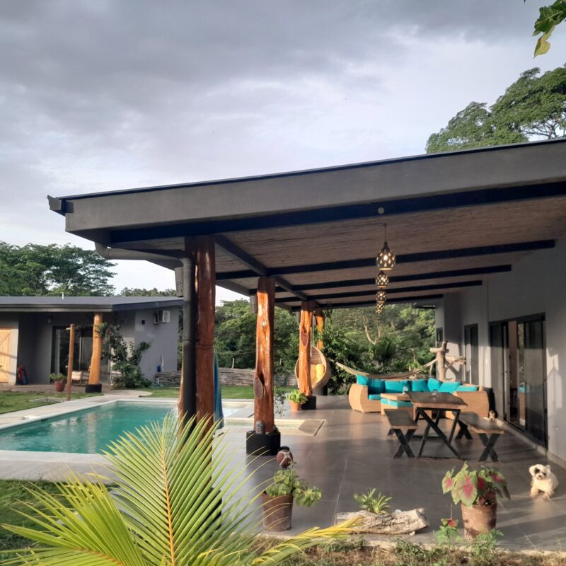 Pool and covered terrace at dusk