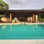 Evening light over the pool and outdoor lounge