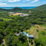House on land in Big Sky Ranch — aerial with the Pacific in the distance