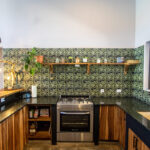 House on land in Big Sky Ranch — kitchen with patterned tile and wood cabinetry