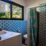 Blue-tiled bathroom with soaking tub