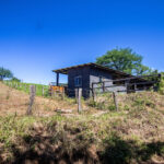 Open pasture with the casita and outbuildings