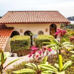 Tile-roofed villa exterior with tropical garden in Pelican Eyes