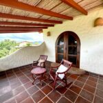Ocean view home in Pelican Eyes — terrace table overlooking the water