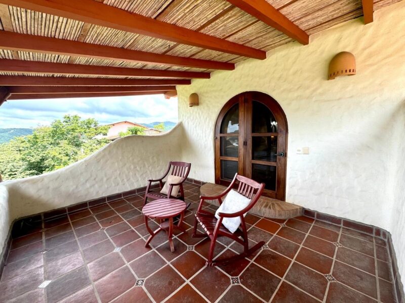 Ocean view home in Pelican Eyes — terrace table overlooking the water