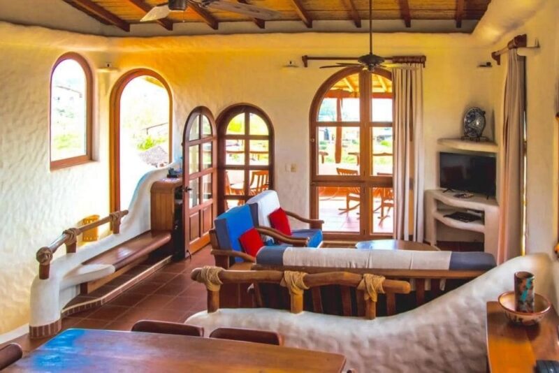 Living room with built-in seating and arched windows
