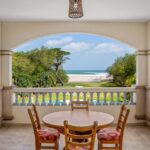 Covered terrace with dining table and Pacific Ocean view