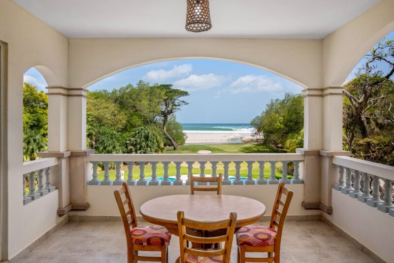 Covered terrace with dining table and Pacific Ocean view