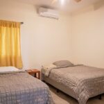 Second bedroom with twin beds and air conditioning