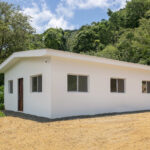 Starter home near Playa Yankee — new single-story house on a hillside lot