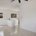 Open living room and kitchen with peninsula and ceiling fan