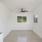 Dining and living space with tile floors and valley-facing window
