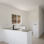 Starter home near Playa Yankee — kitchen with peninsula and hallway to bedrooms