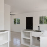 Kitchen with open shelving and concrete countertops