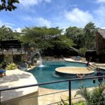 Family pool with swim-up seating at the resort