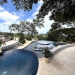 Infinity pool and sun loungers at TreeCasa Resort