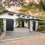 Front entrance and private gate of Lomas de Palermo home at sunset