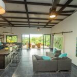 Open living room and kitchen under beamed ceilings