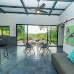 Great room with artwork, ceiling fan and garden views