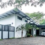 Side of the house with carport and privacy fence
