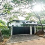 Vehicle gate and perimeter wall at the front of the property