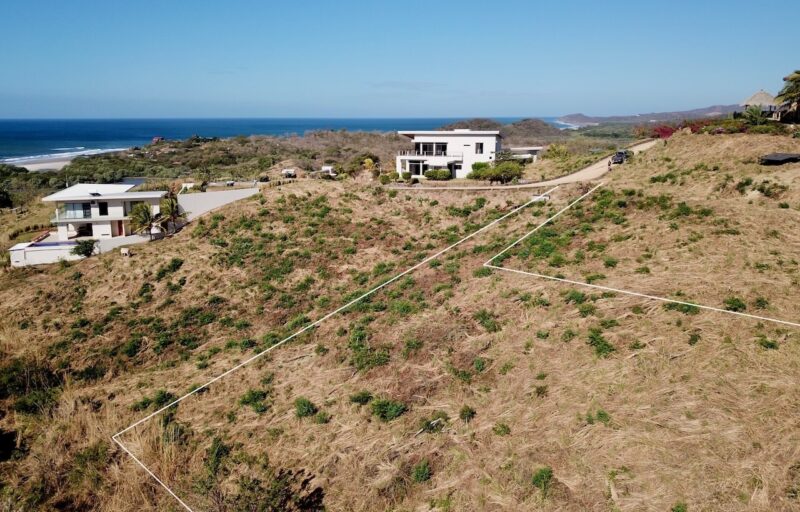 Lot boundary outlined on the hillside with the ocean beyond