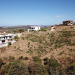 Ocean view lot in Popoyo — wide view of the hillside lot and neighboring homes