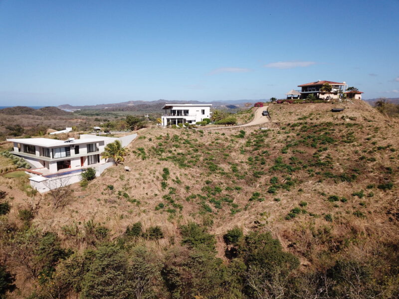 Ocean view lot in Popoyo — wide view of the hillside lot and neighboring homes