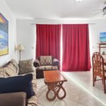 Oceanfront condo at Casa Marina — living room with ceiling fan