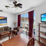 Living and dining area opening to the ocean-view balcony