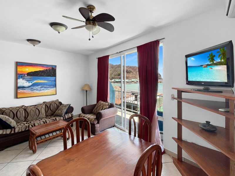Living and dining area opening to the ocean-view balcony