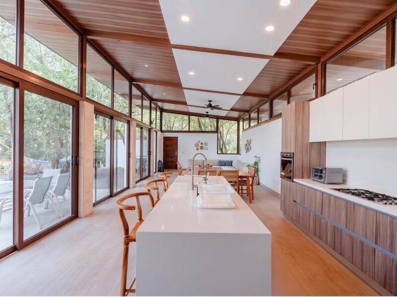 Open kitchen with long island and clerestory windows in Hacienda Iguana home