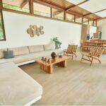 Living room with sectional sofa and open plan dining at Hacienda Iguana pool home