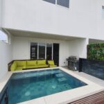 Private pool and wooden deck behind the townhouse