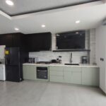 Kitchen with dark cabinetry and stainless appliances